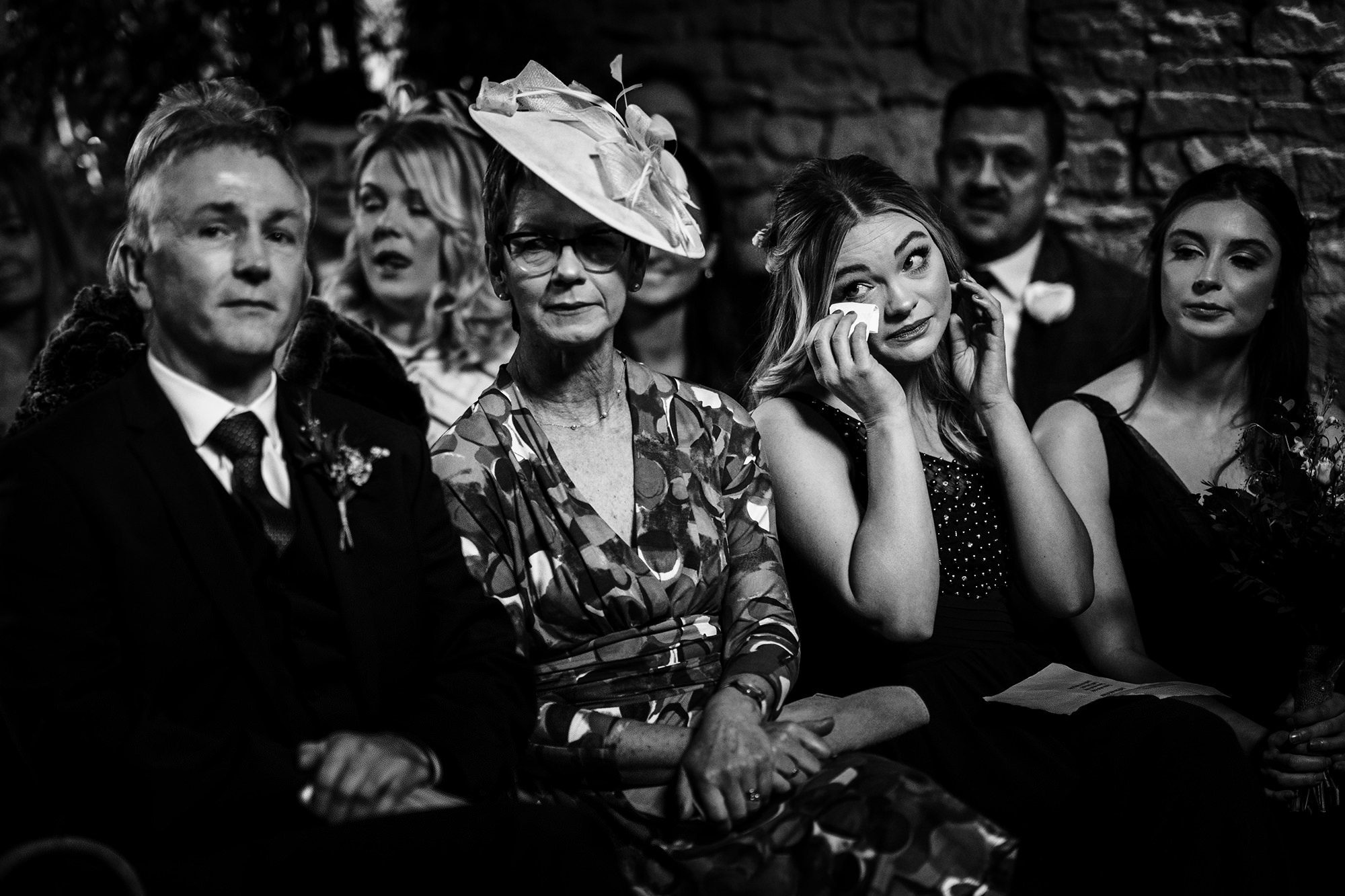a bridesmaid wipes her tear at Cripps Barn in The Cotswolds