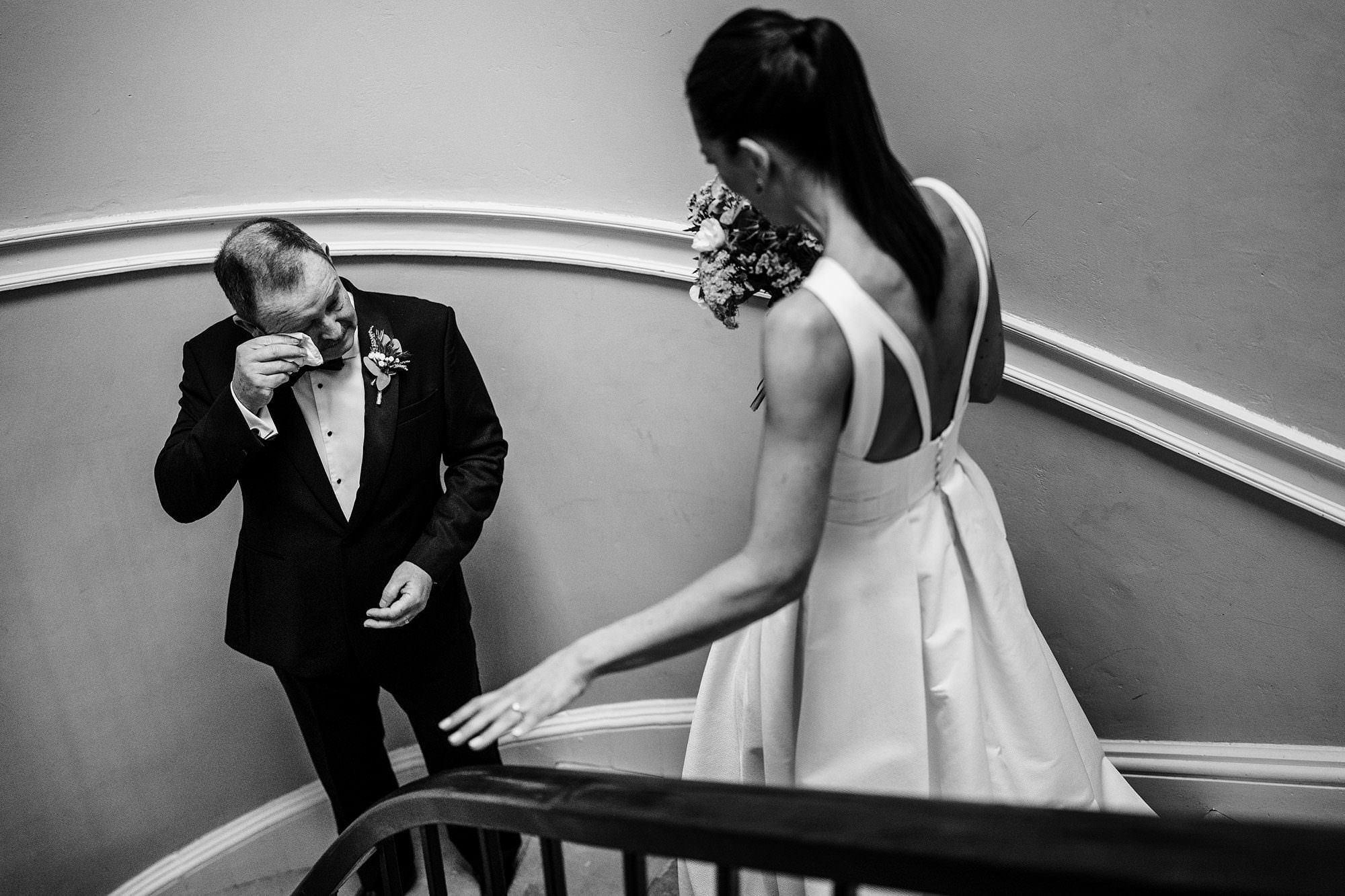 bride approaches her father who is crying