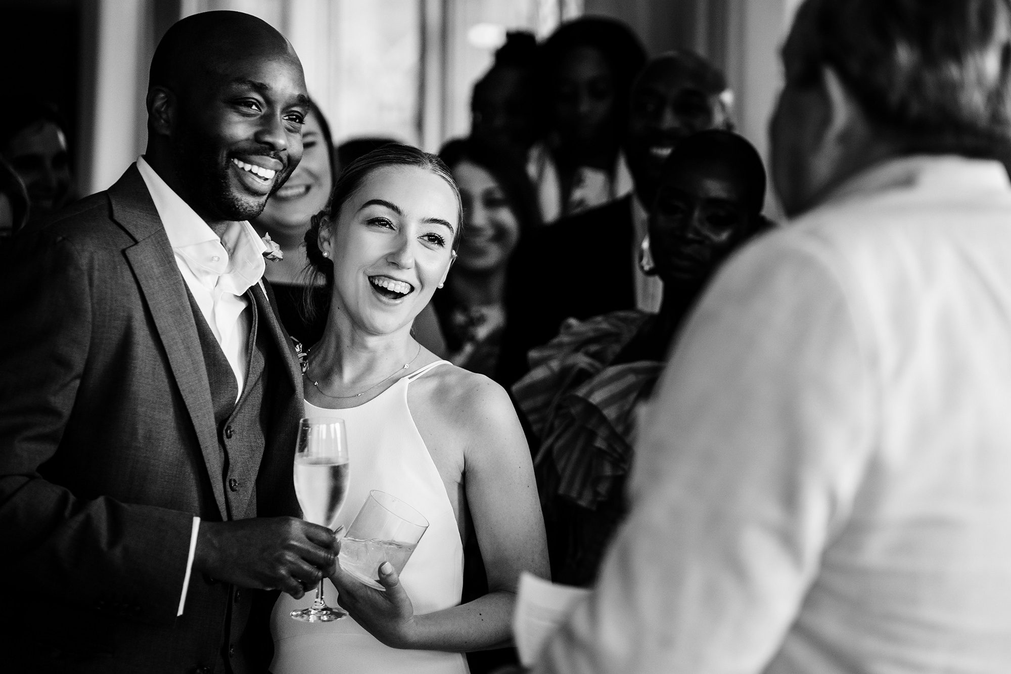 bride and groom laughing during speeches at wedding
