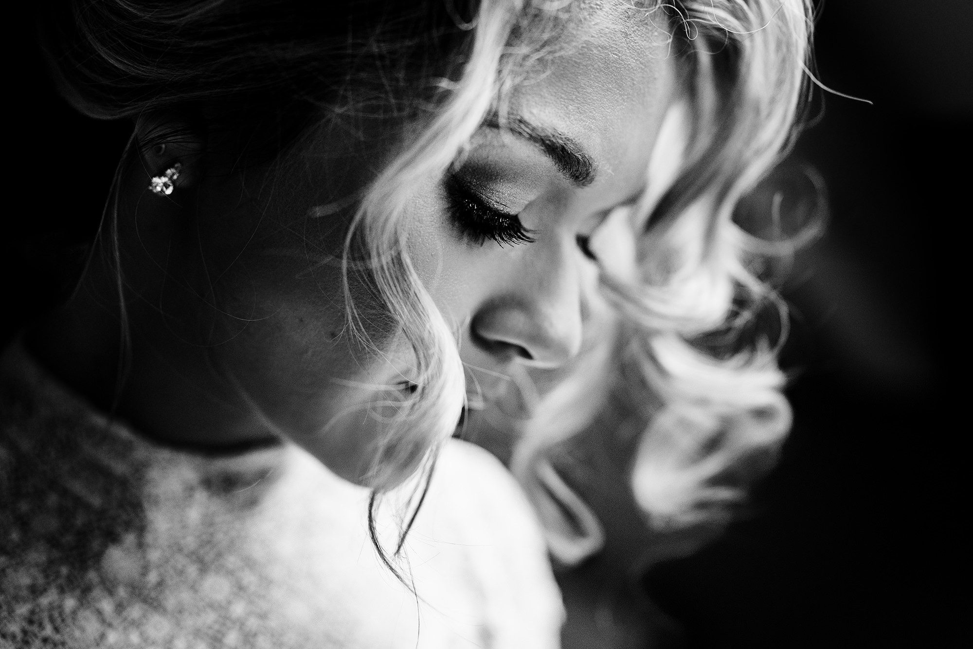 a close up of a cotswolds bride having her make up applied