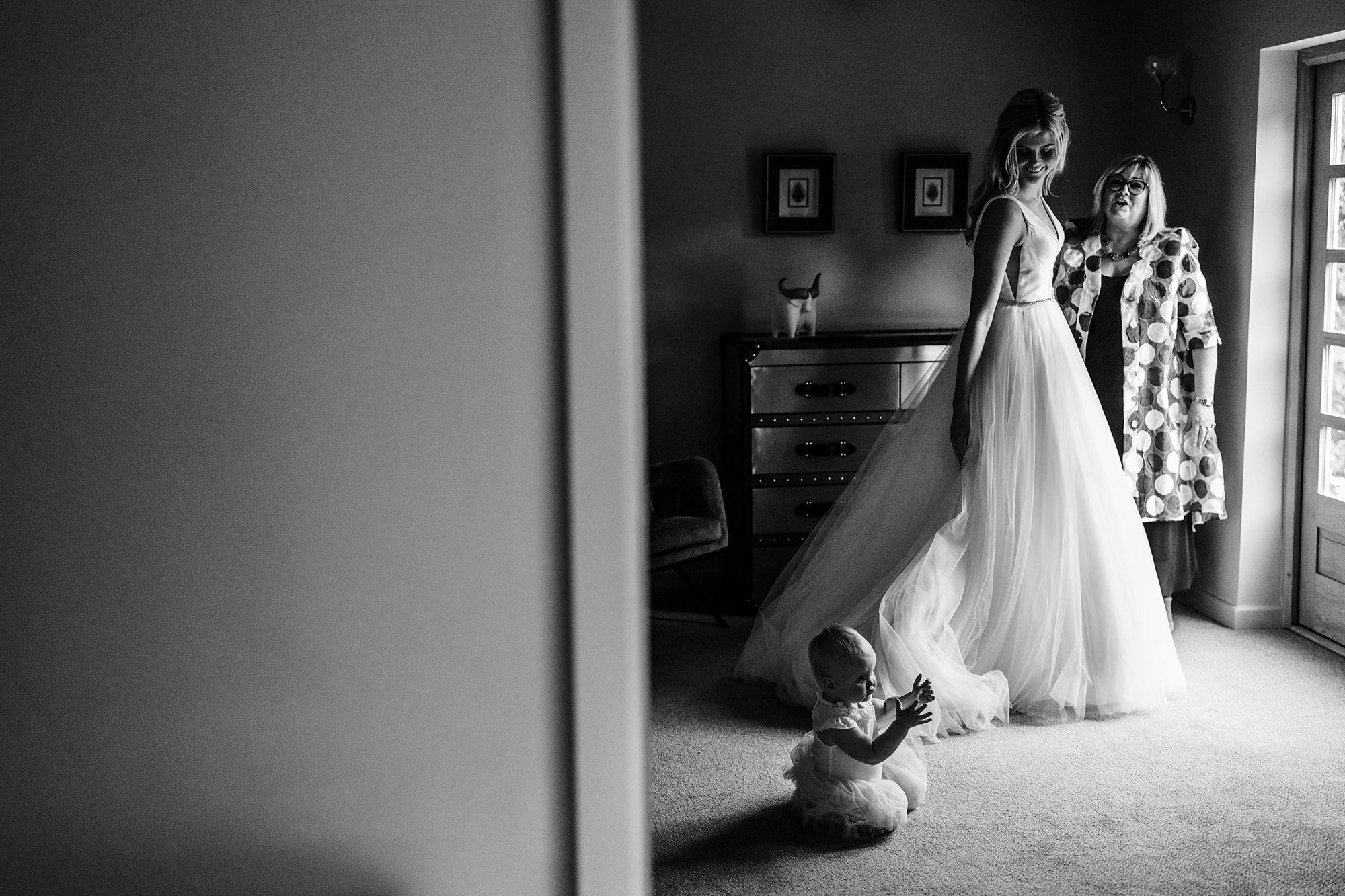 bride looks down at daughter on the morning of her wedding