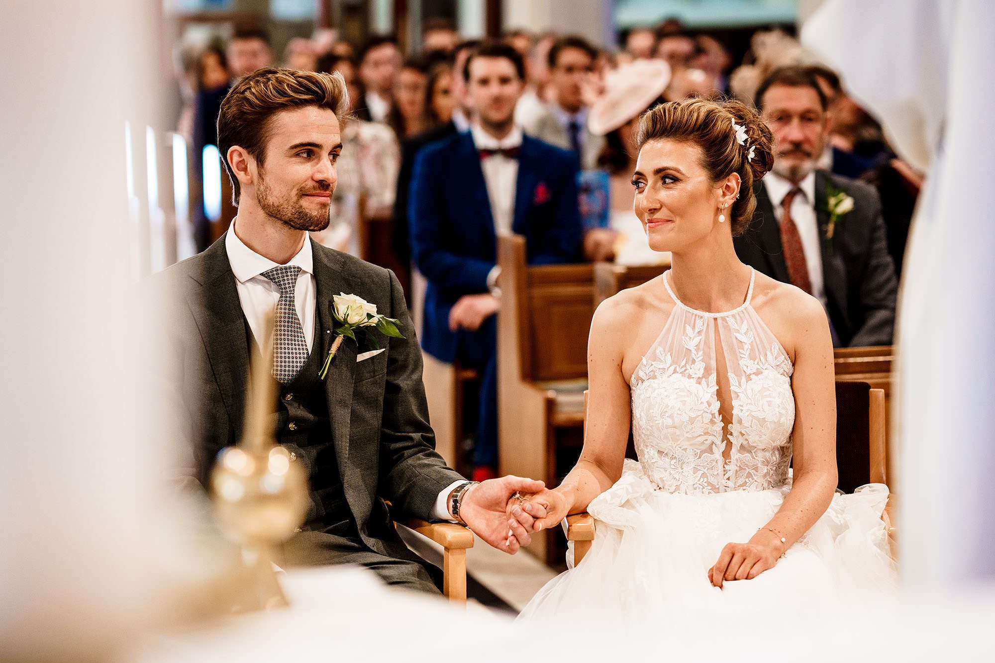 bride and groom hold hands during Lake District wedding ceremony