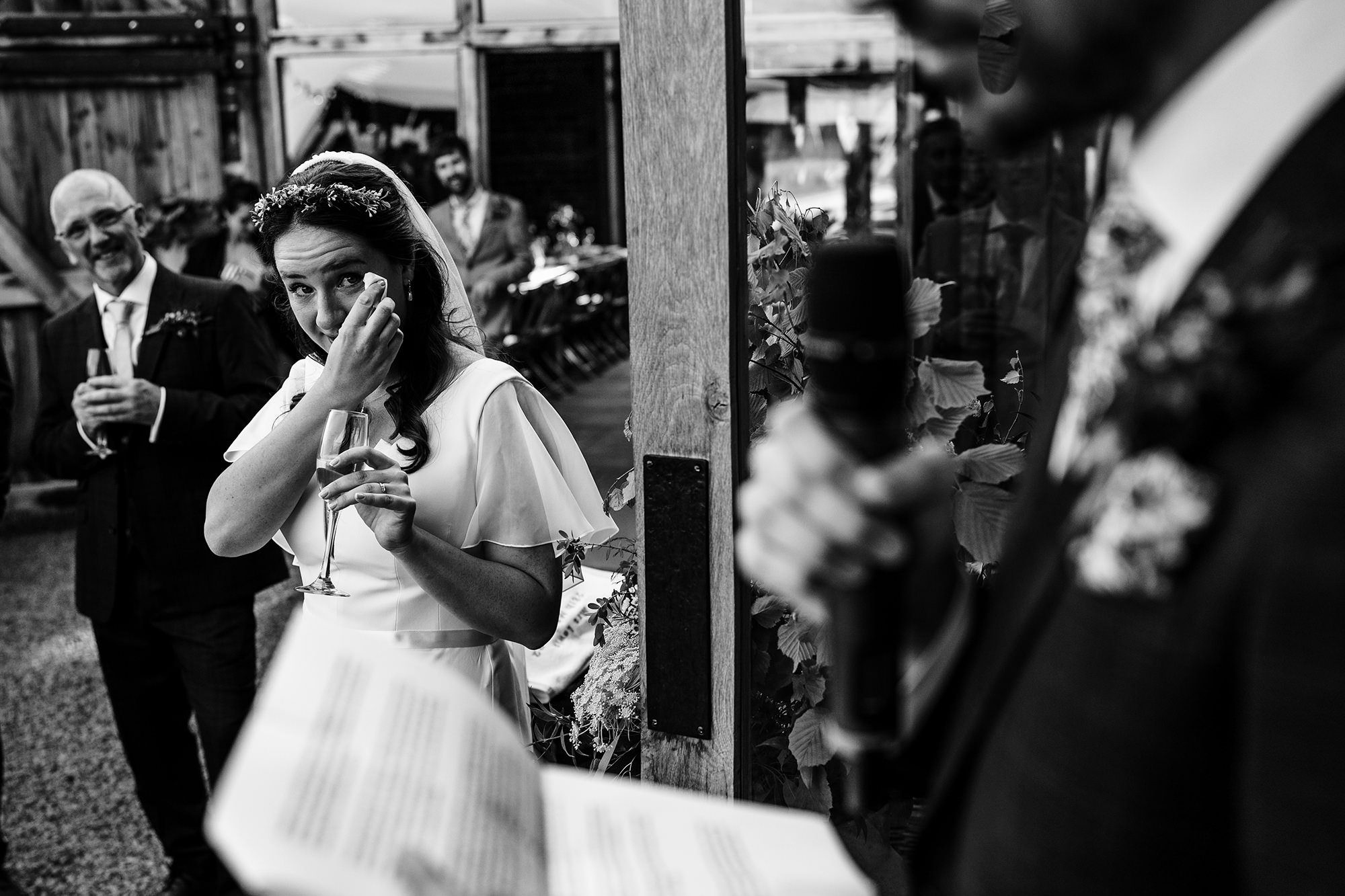 bride crying watching her husband give speech on Windermere